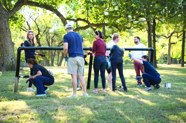 Volunteers from area apartments clean up lake